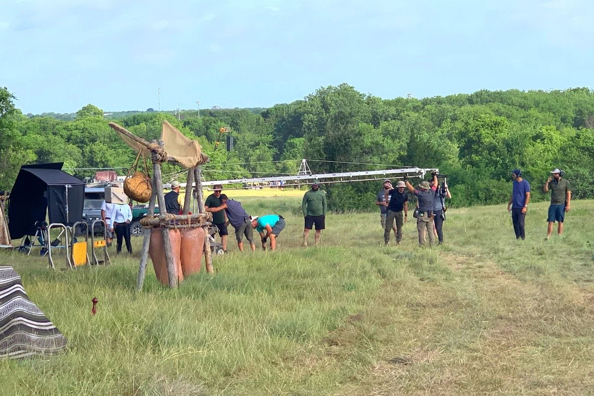 The crew work on a boom by The Chosen camp set